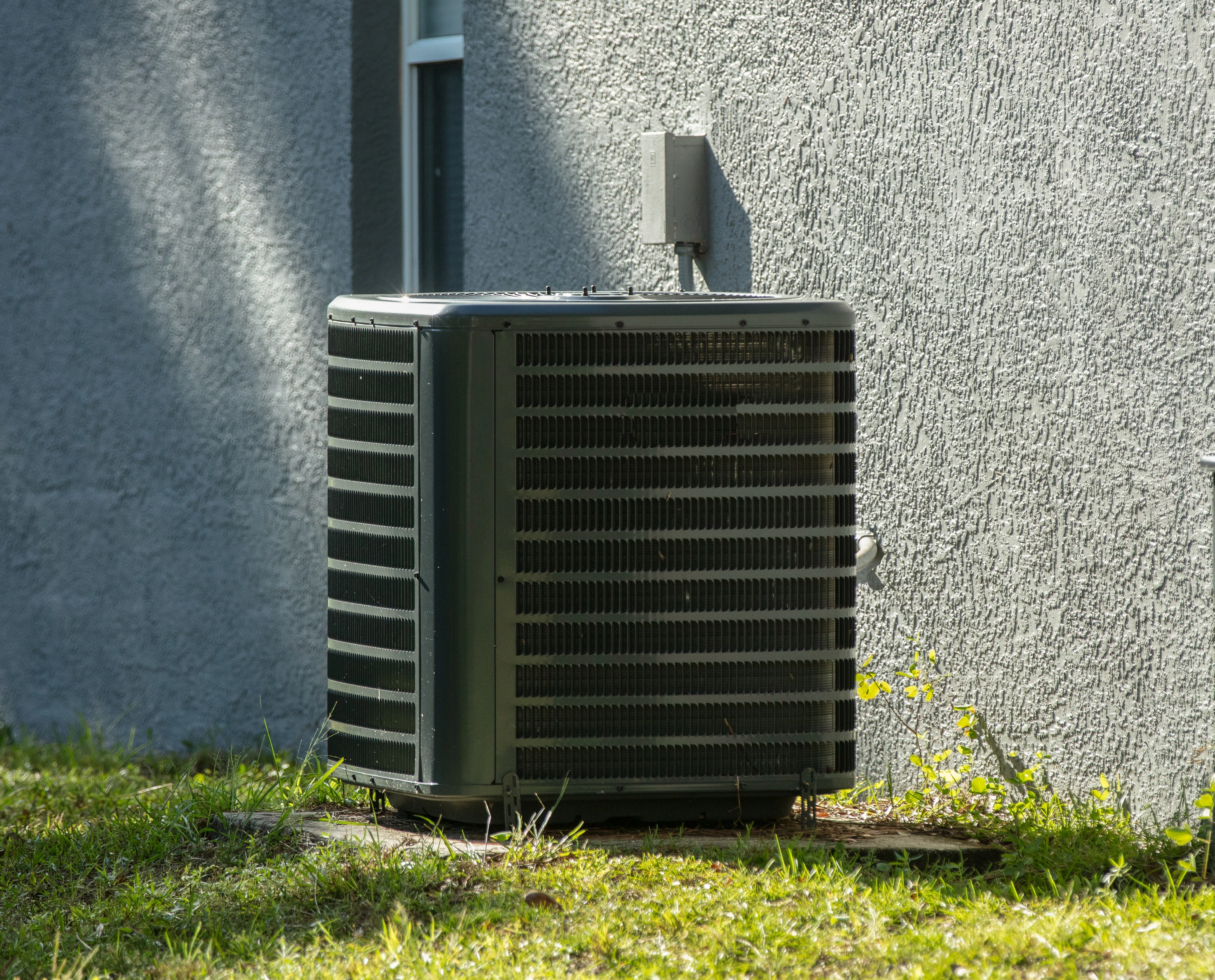 A clean outdoor air conditioner unit after a successful AC tune-up by Air Dynamics in Tulsa.