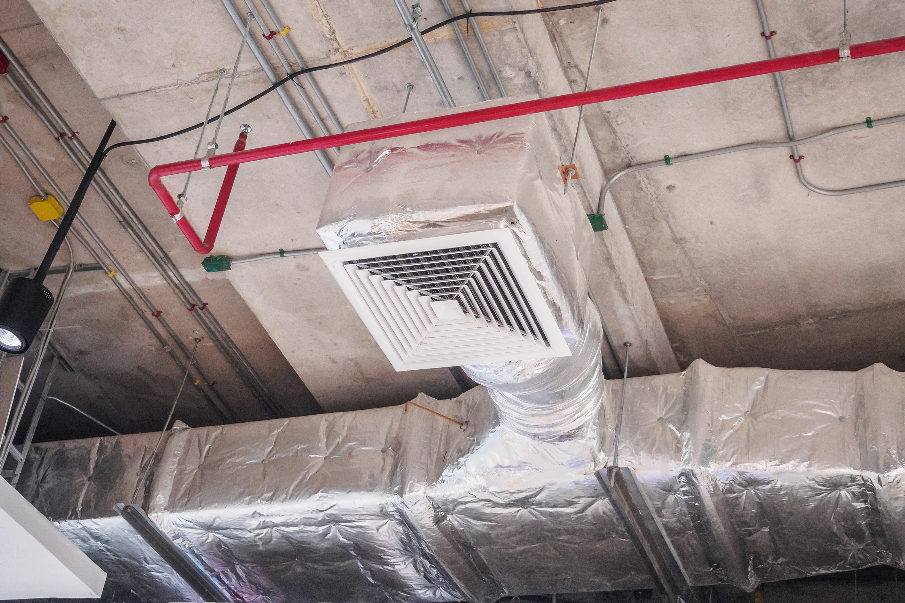 Insulated ductwork in a commercial facility, part of a comprehensive HVAC service in Tulsa.